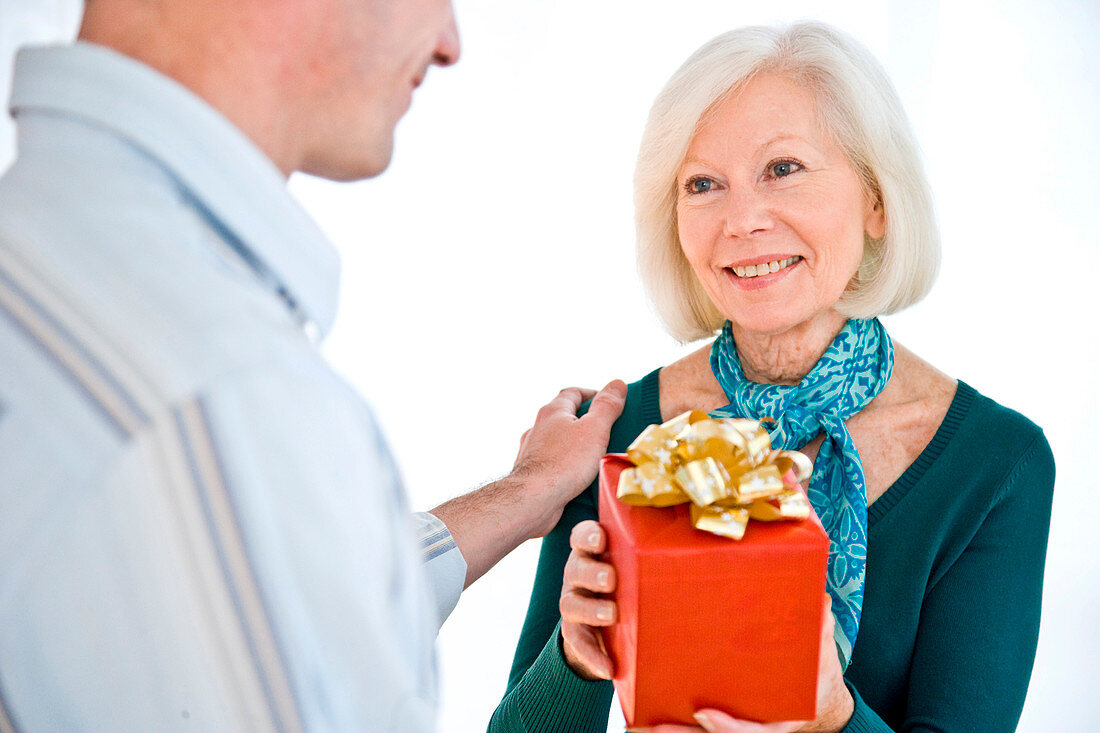 Elderly woman receiving a present