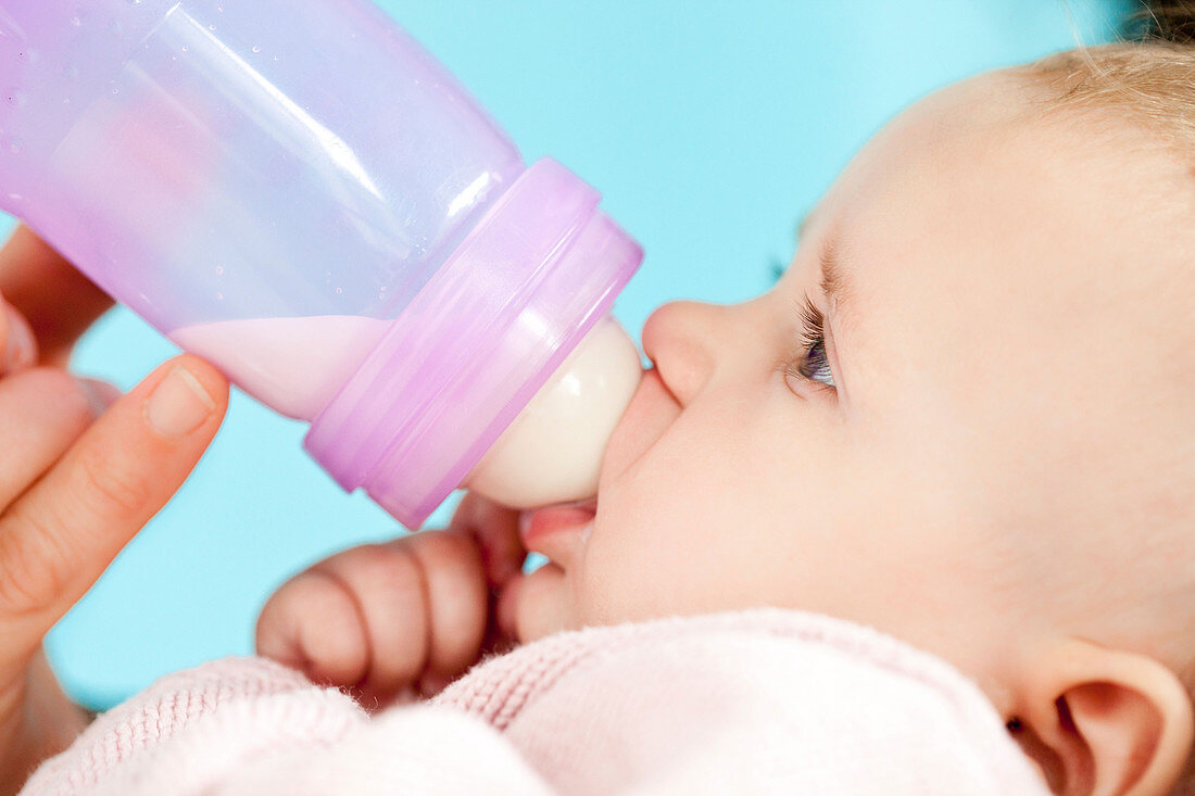 Baby with feeding bottle