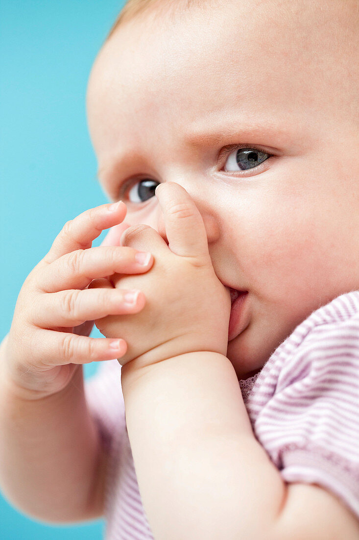 Baby girl sucking her thumb