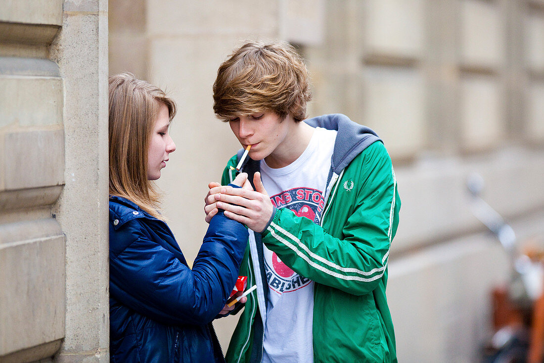 Teenagers smoking a cigarette