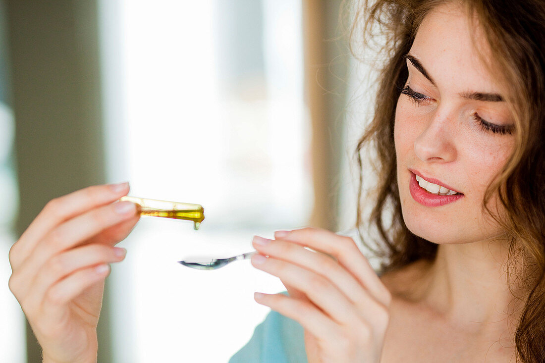 Woman holding ampoule of vitamin D