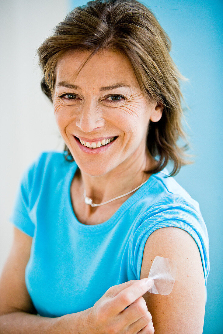 Woman applying a patch