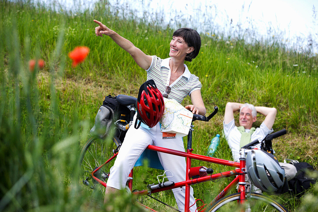 Senior couple riding tandem bicycle