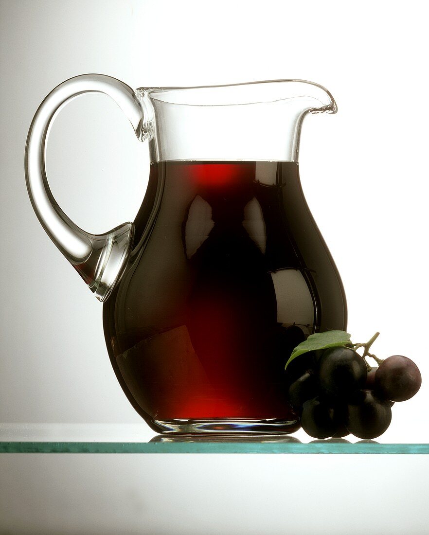 Grape Juice in a Glass Decanter; Grapes