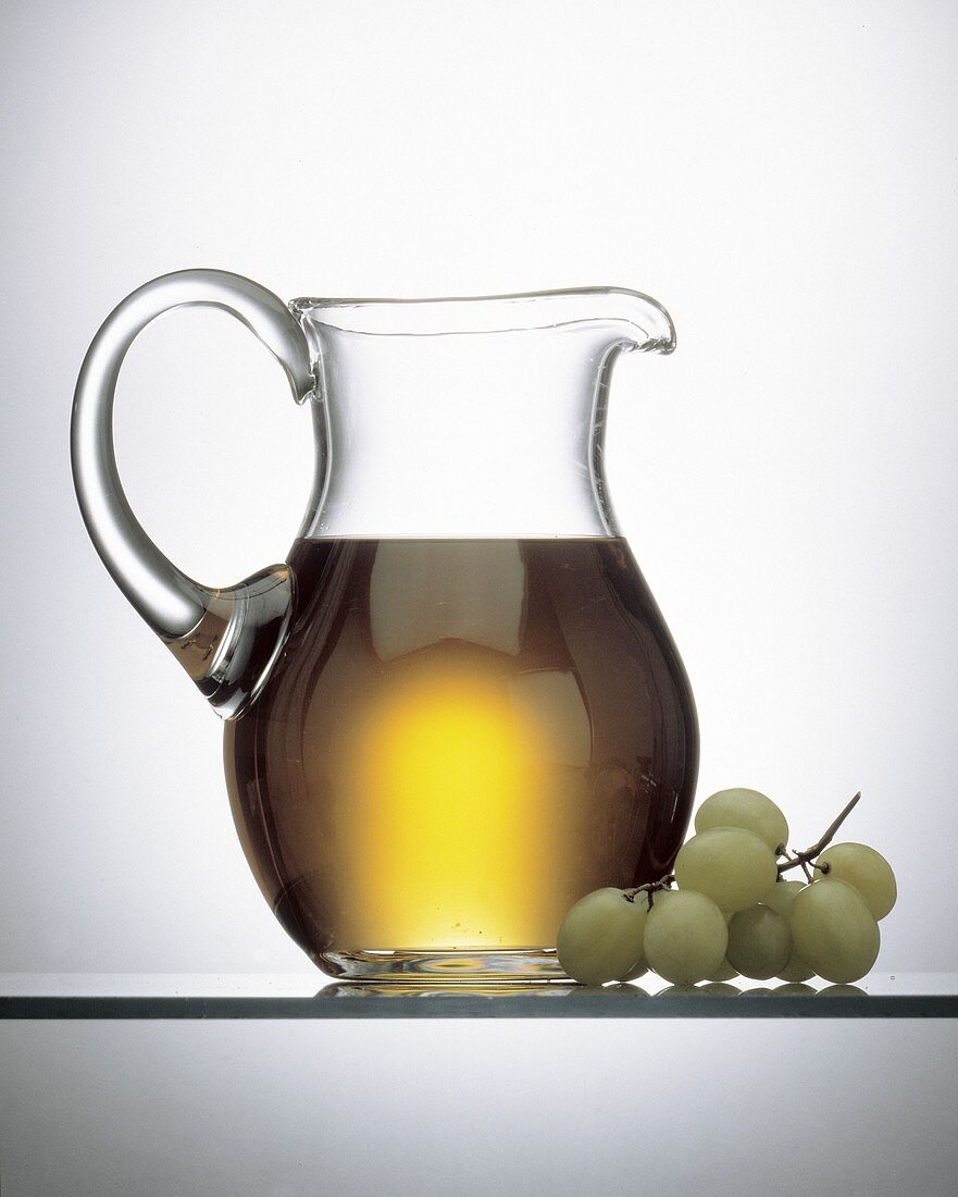 White Grape Juice in a Pitcher; Grapes