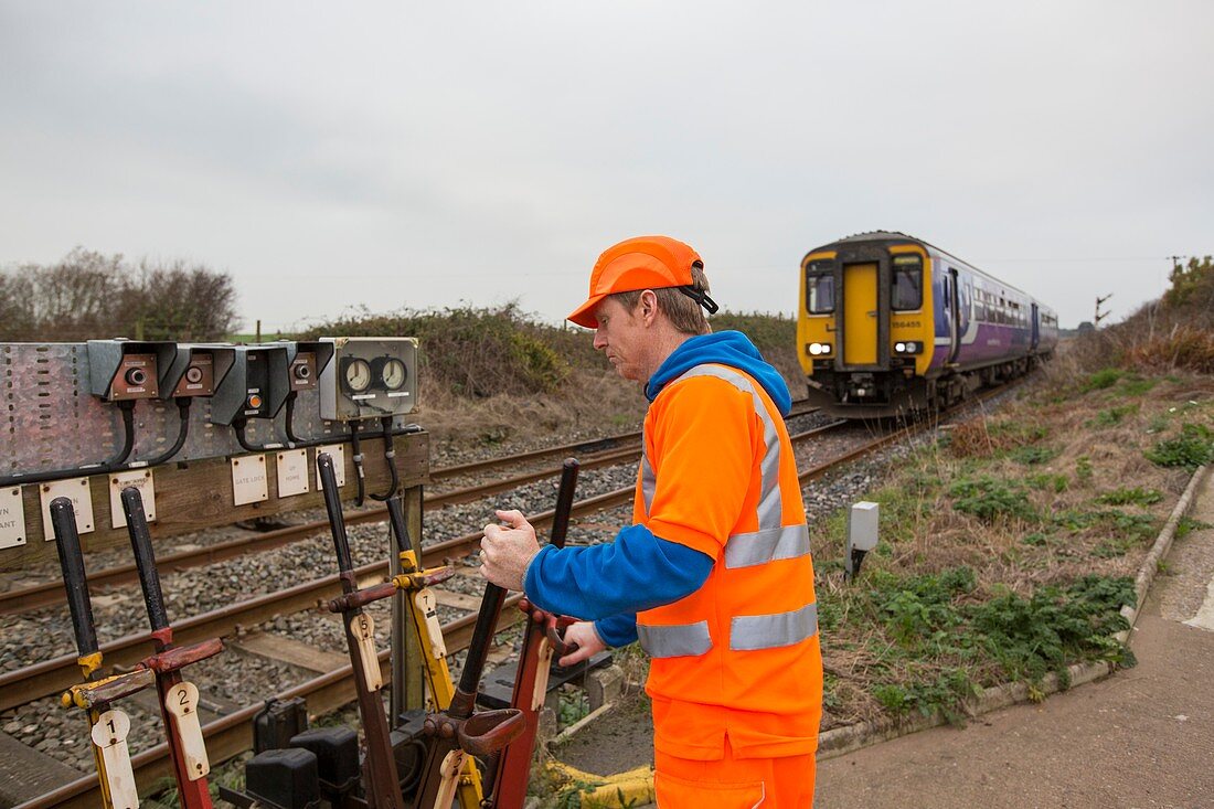 Man switching points at a level crossing