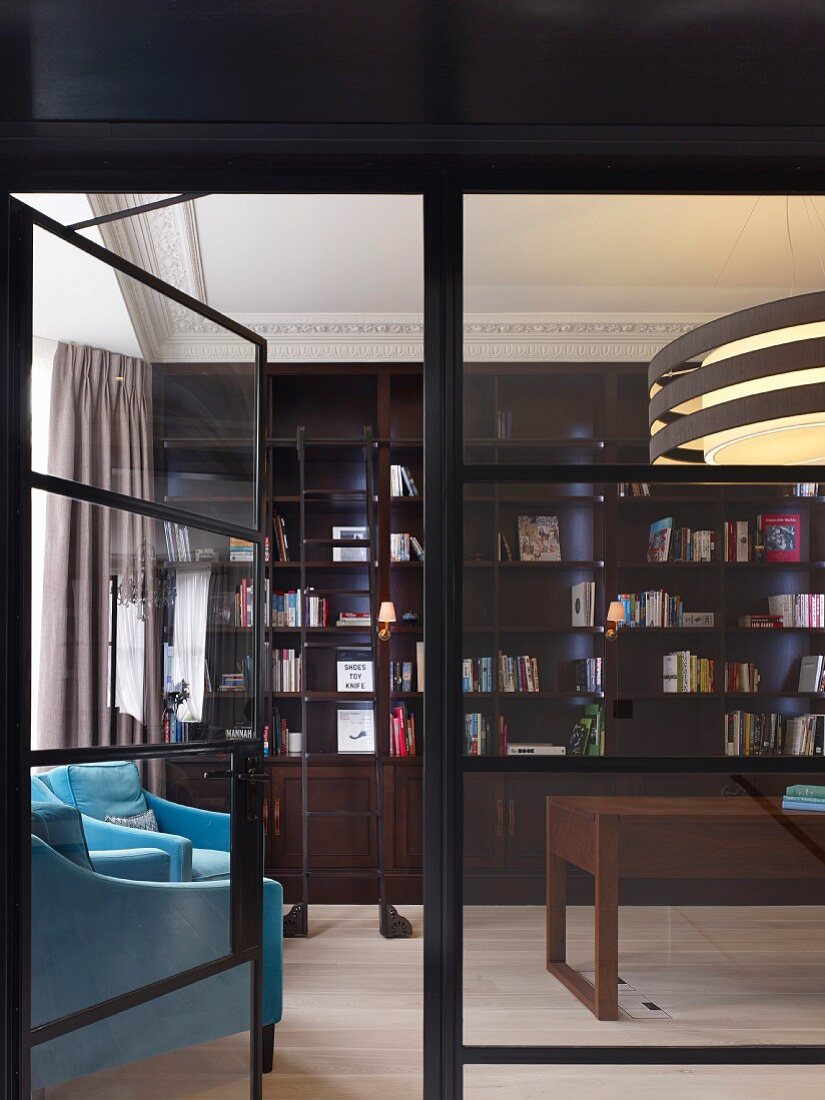 Elegant traditional library with turquoise reading chairs