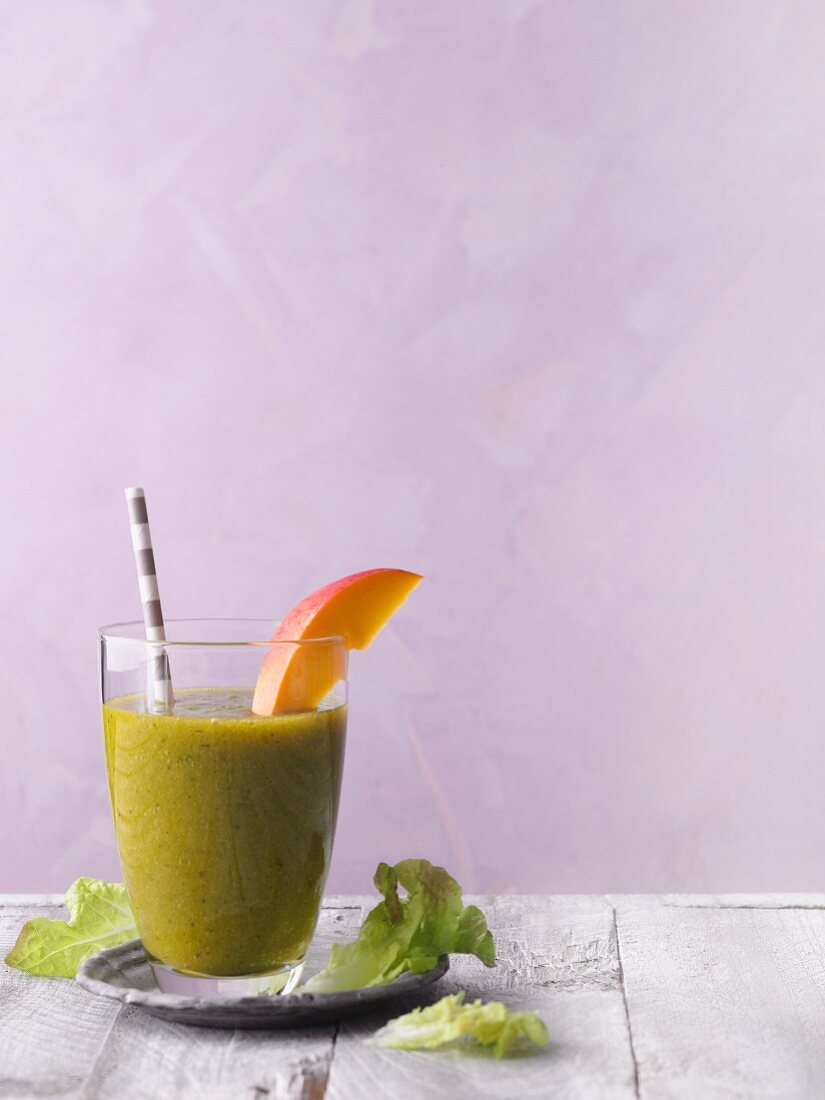 A green smoothie with mango and lettuce