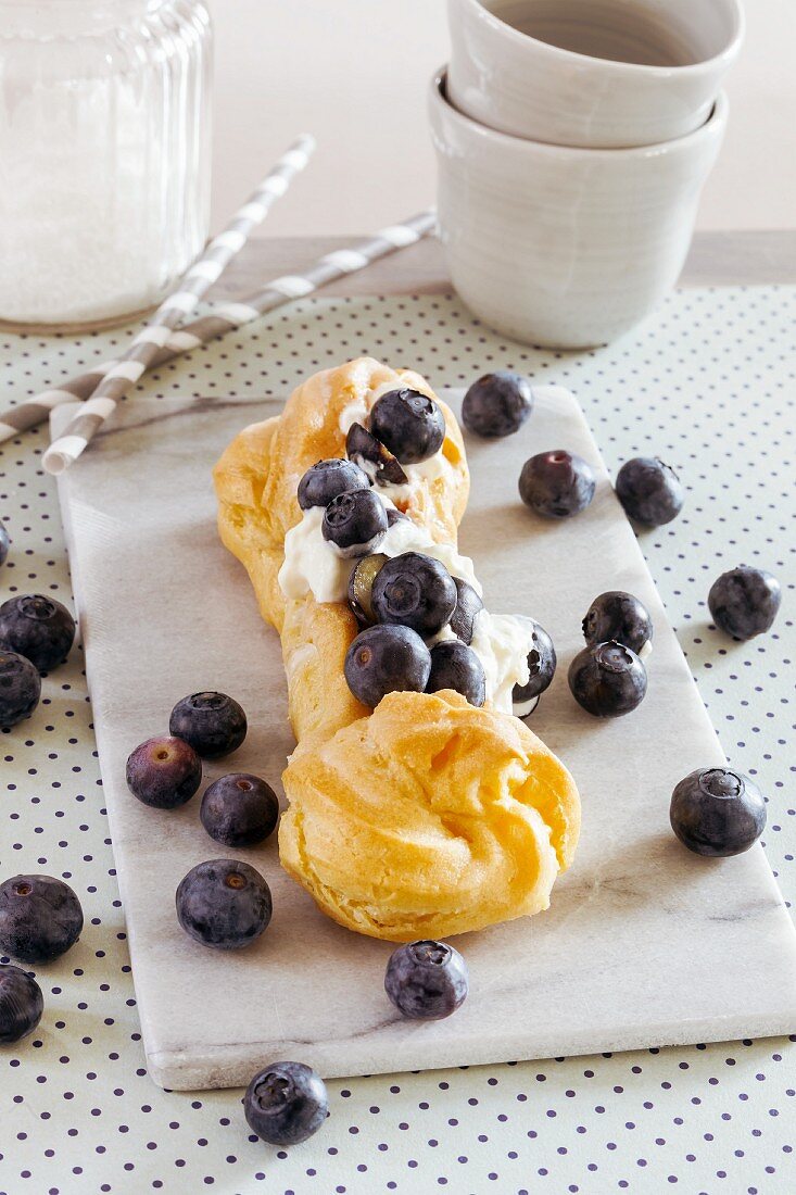 An eclair with blueberries