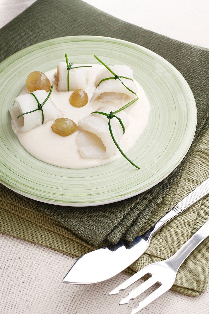 Plaice rolls with white grapes and Bechamel sauce