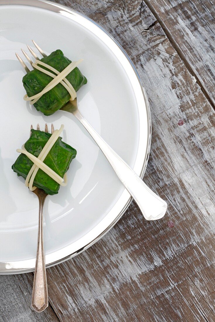 Salmon parcels wrapped in spinach leaves