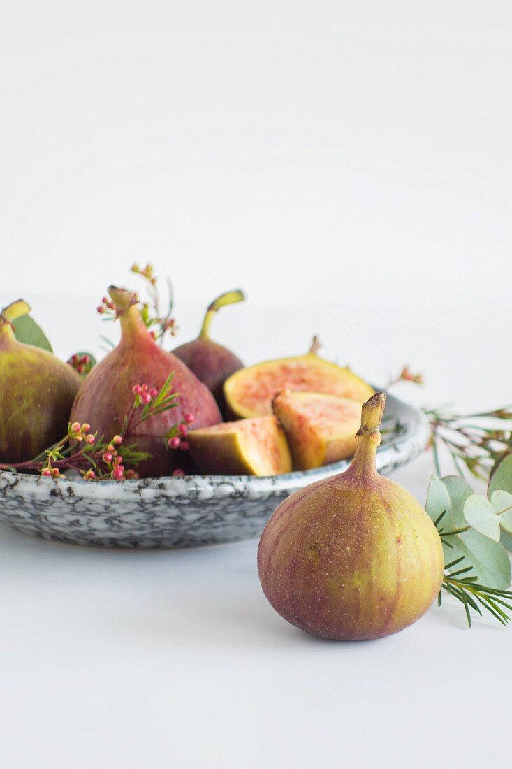 Figs on a marble plate and in front of it