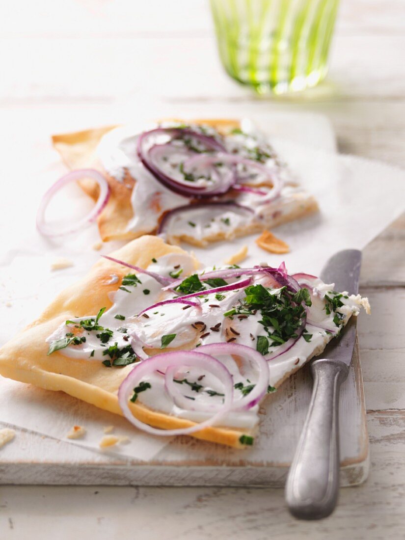 Two slices of tarte flambée with buckwheat flour