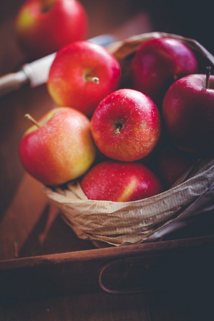 Red apples in a paper bag