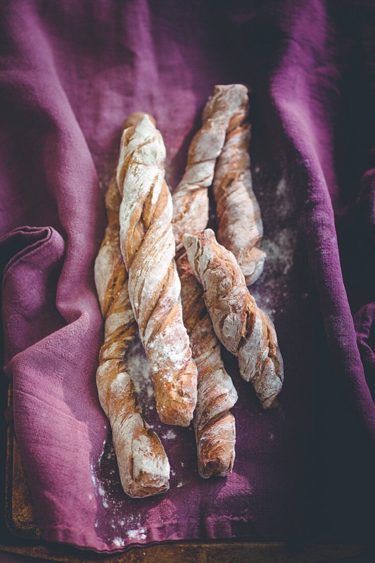 Wurzelbrot (Swiss twisted bread) on a purple cloth