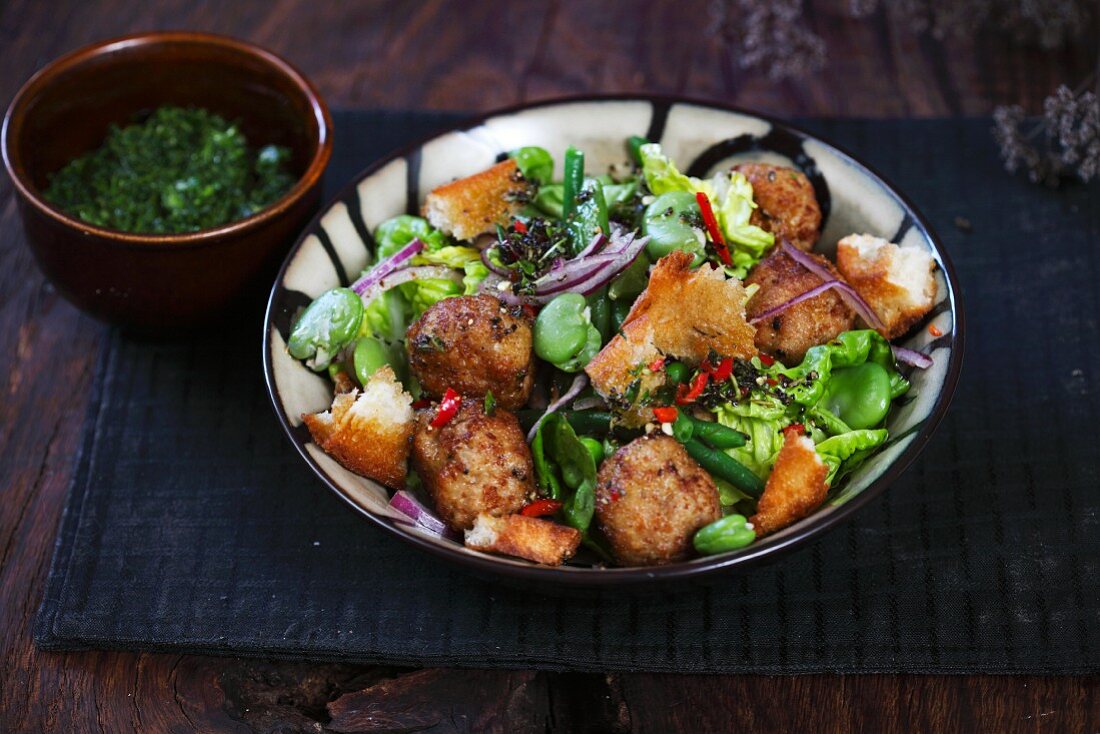 Pork bites with lettuce, green and broad beans