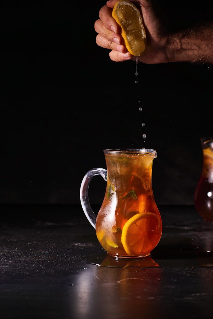 Lemon juice being added to iced tea