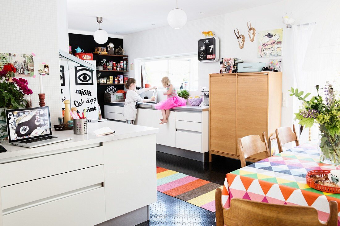 Children in kitchen-dining room with bright accents of colour