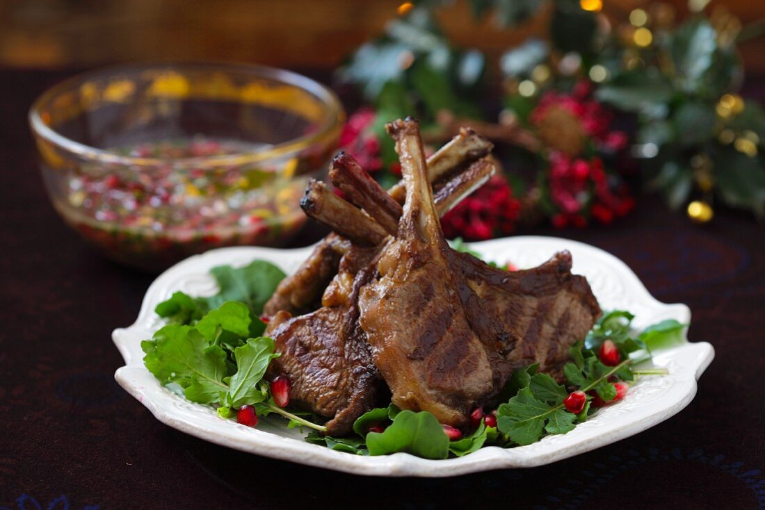 Grilled lamb chops on rocket with pomegranate seeds