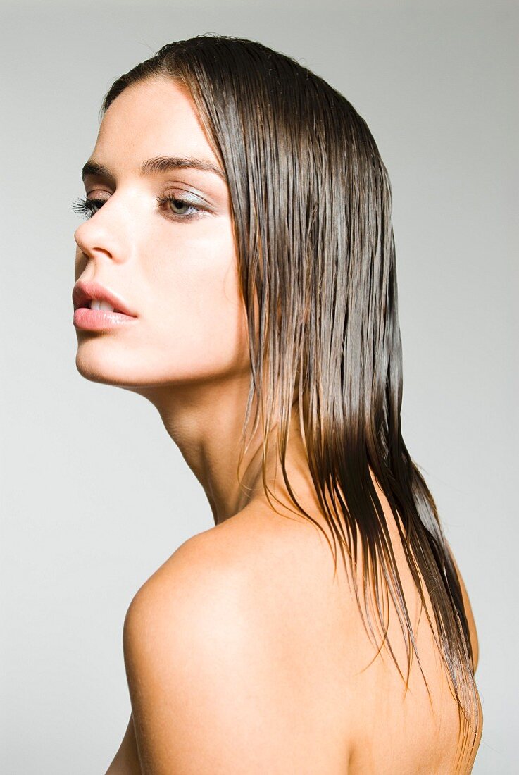 A dark blonde woman with wet hair