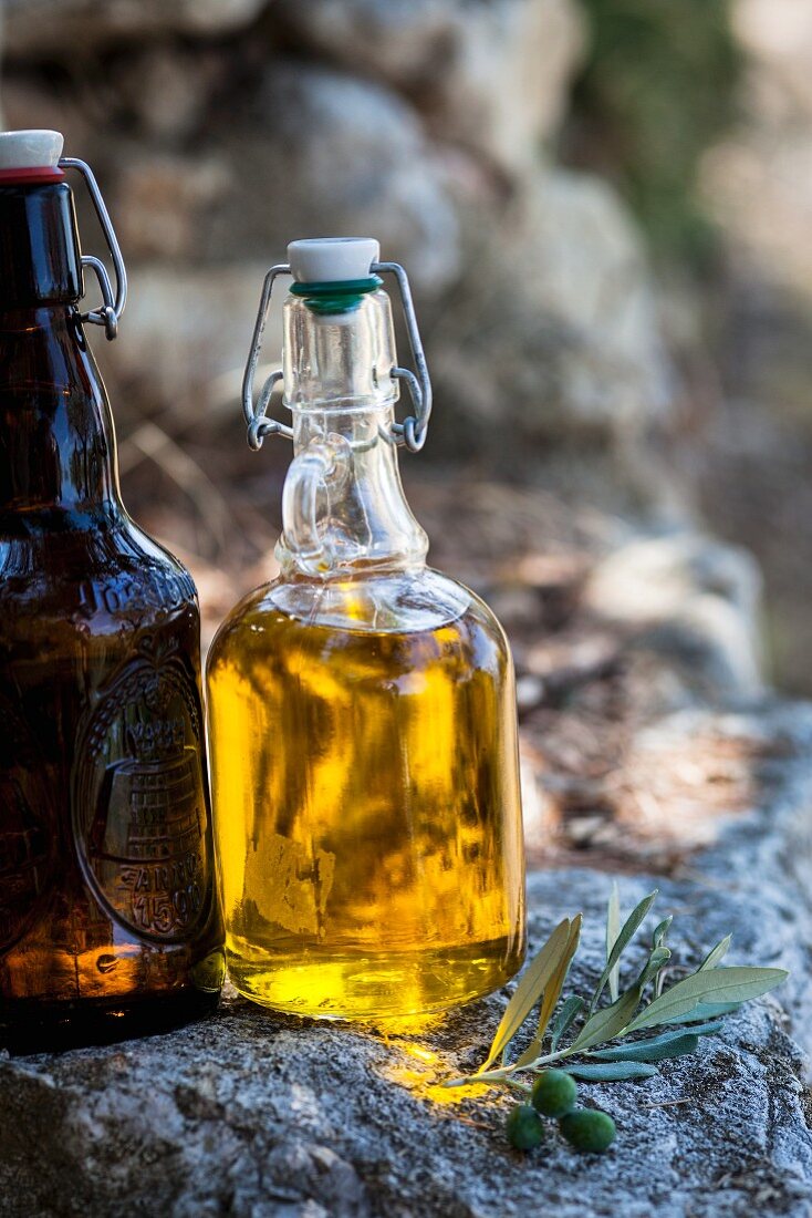 Olive oil in a bottle on a stone wall
