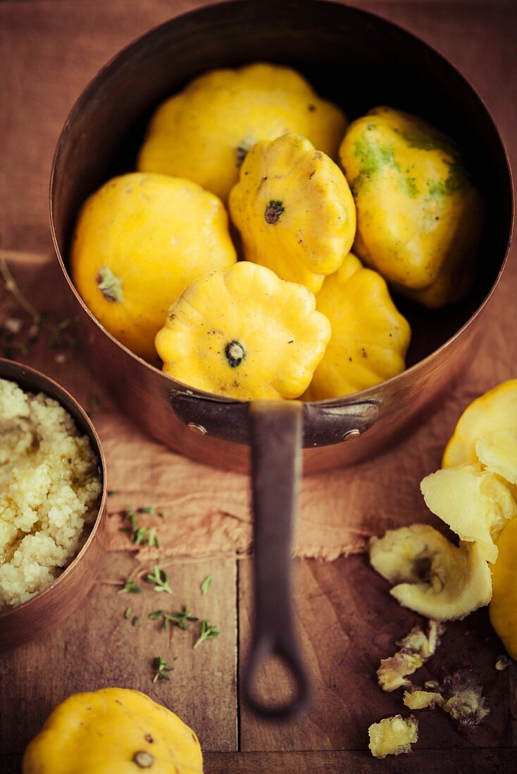 Yellow pattypan squash in a copper pot