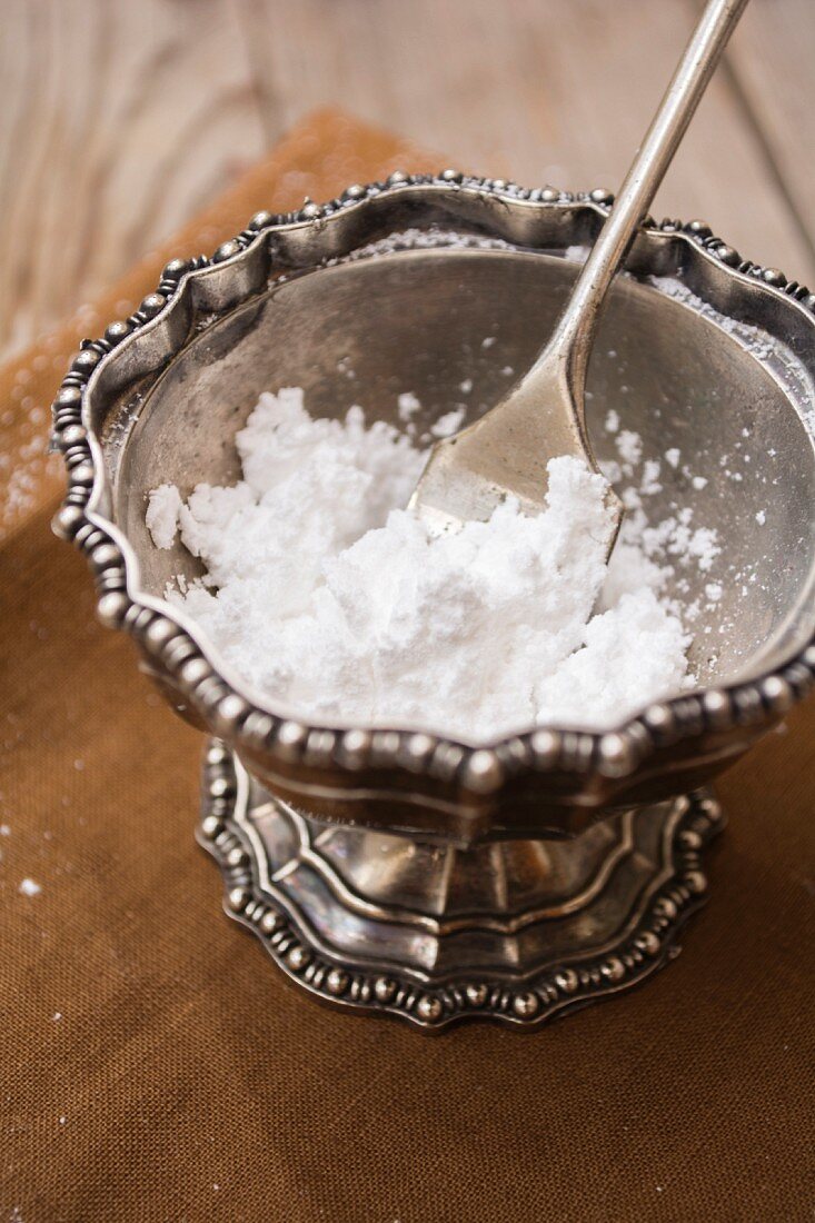 Icing sugar in a old pewter cup