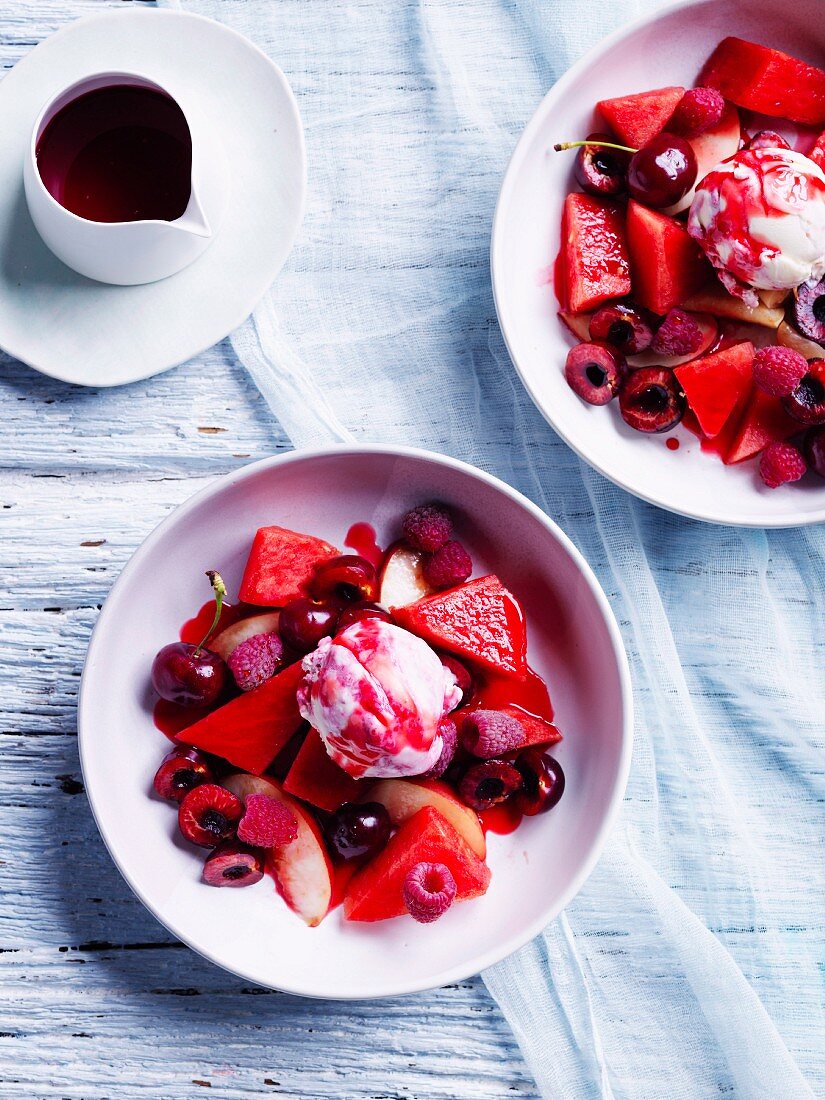 Watermelon fruit salad with ice-cream and raspberry-pepper syrup