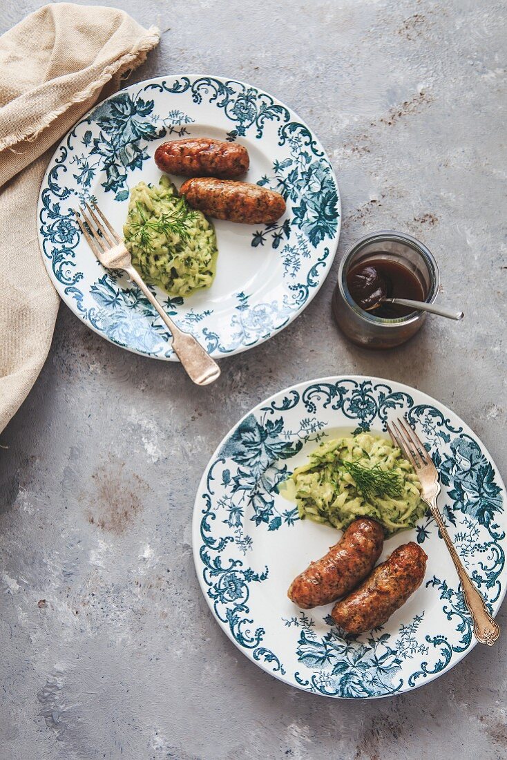 Sausages and mashed courgettes
