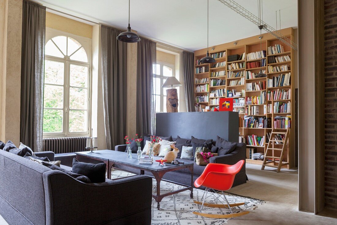 Living room with partition wall and floor-to-ceiling bookcase