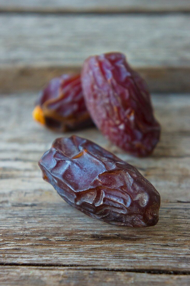 Dried dates on a wooden surface