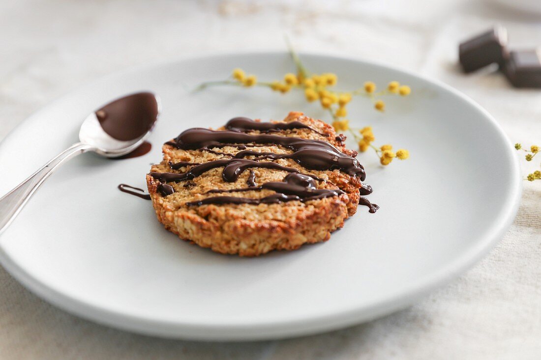 An oat biscuit drizzled with chocolate