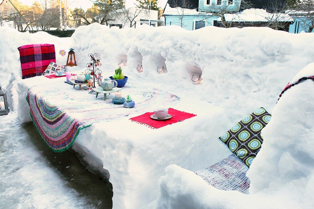 Decorated table sculpted from snow on snow-covered terrace