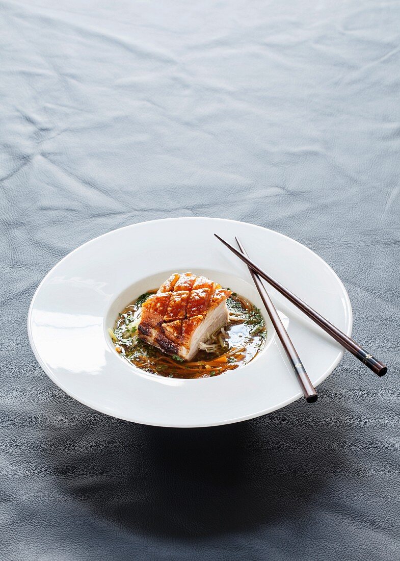 Pork belly in a lemongrass and coriander broth with vegetable strips and herbs