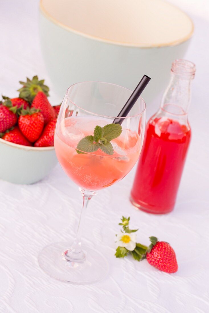 Champagne with ice and rhubarb and strawberry syrup