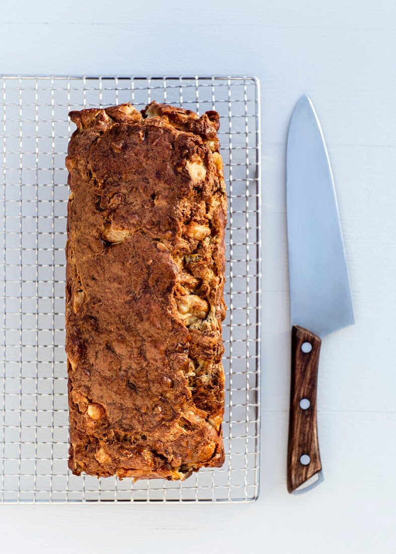 A savoury pear and walnut cake on a wire rack