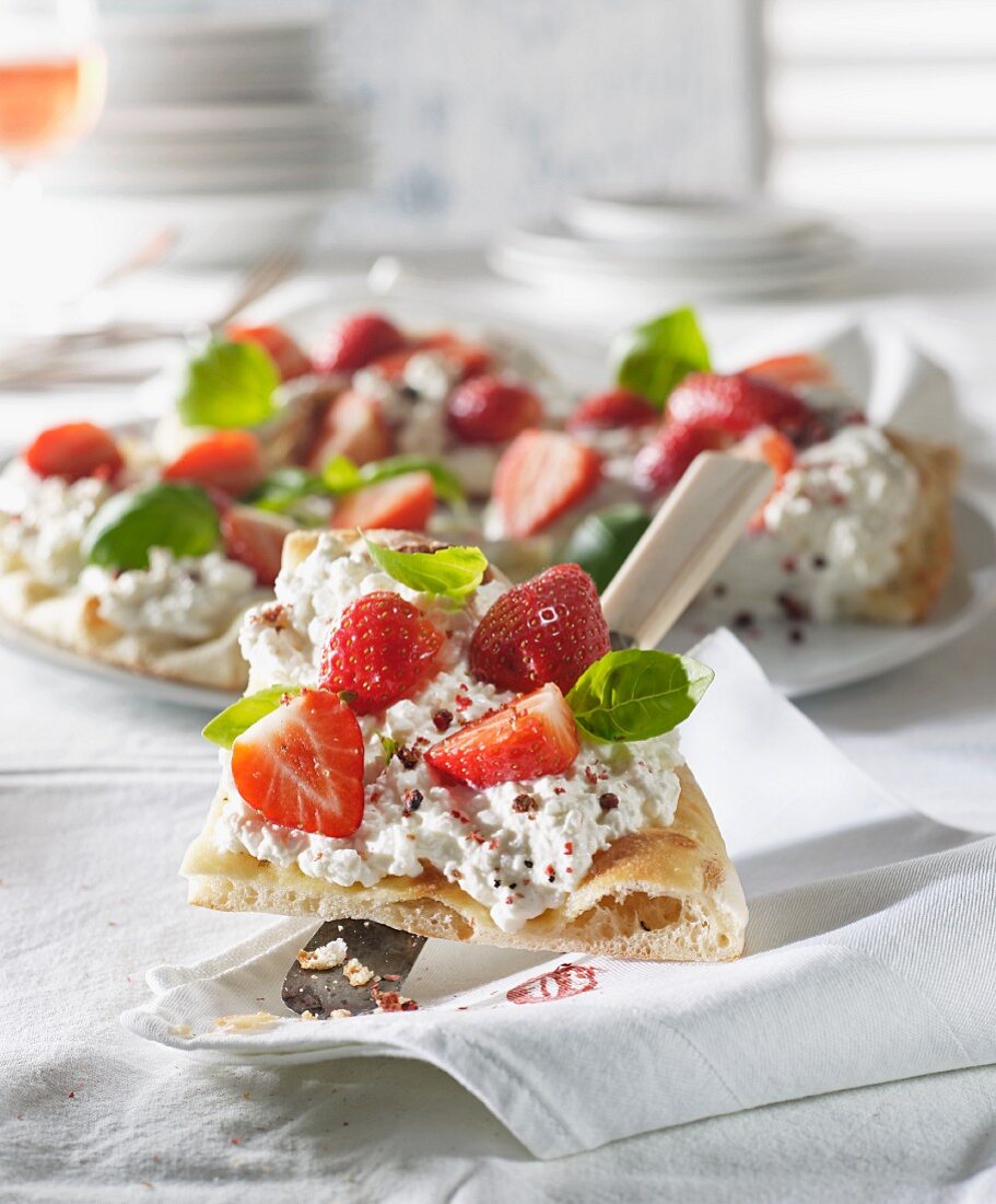 Pizza with cream cheese, strawberries, basil and pepper