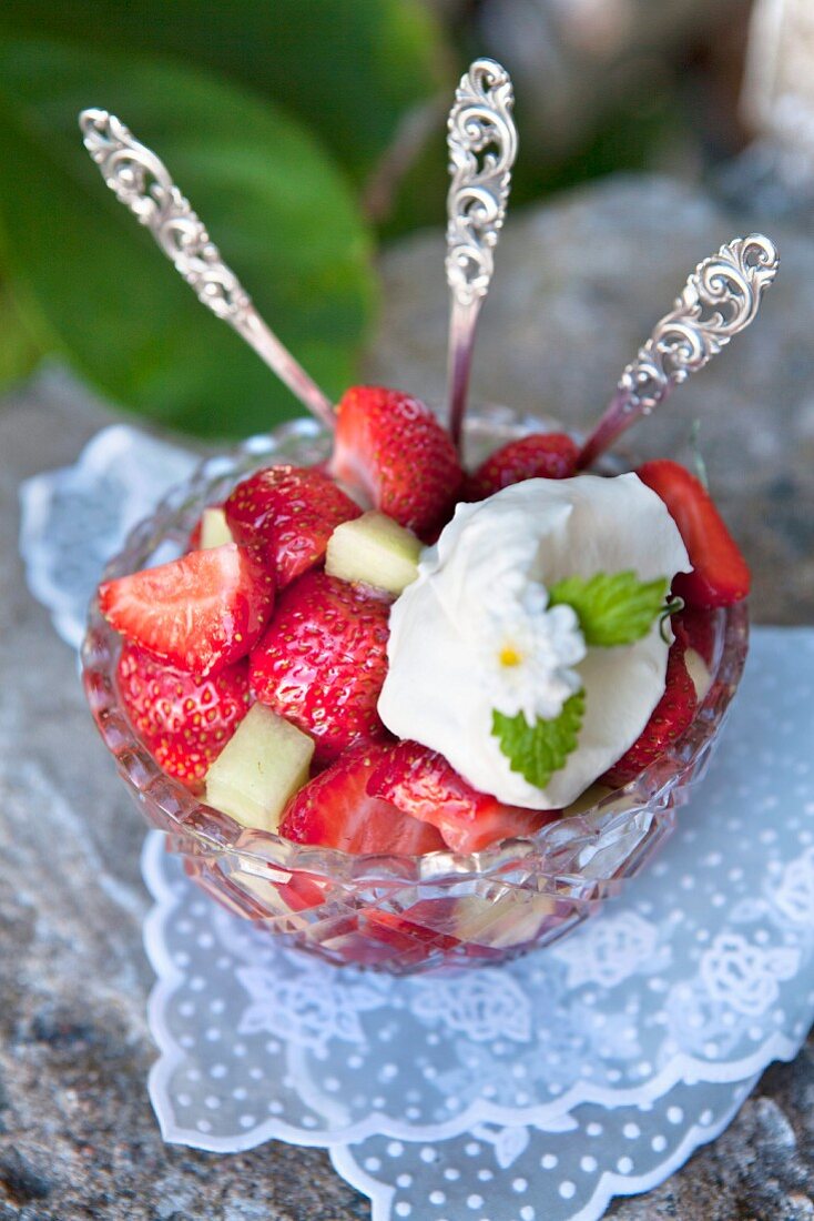 Strawberries with melon and whipped cream