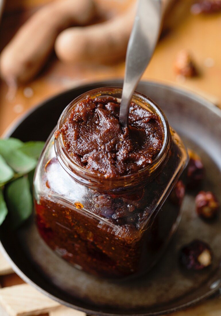 Tamarind chutney and a jar with a spoon
