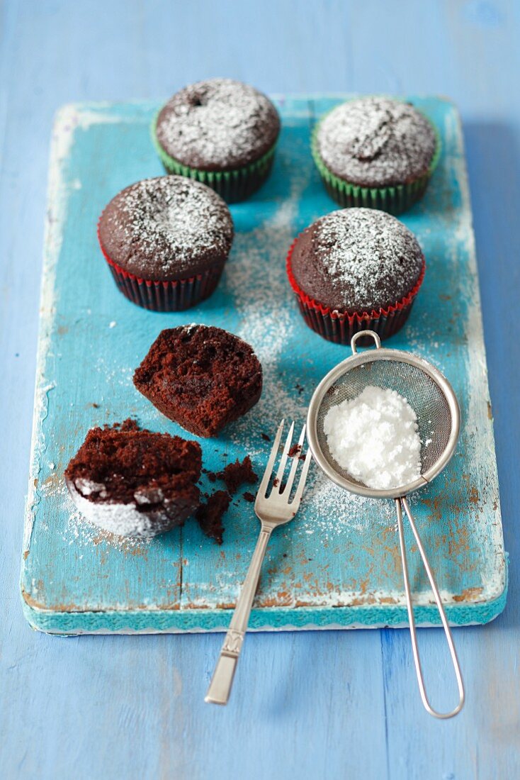 Chocolate muffins with jam and icing sugar