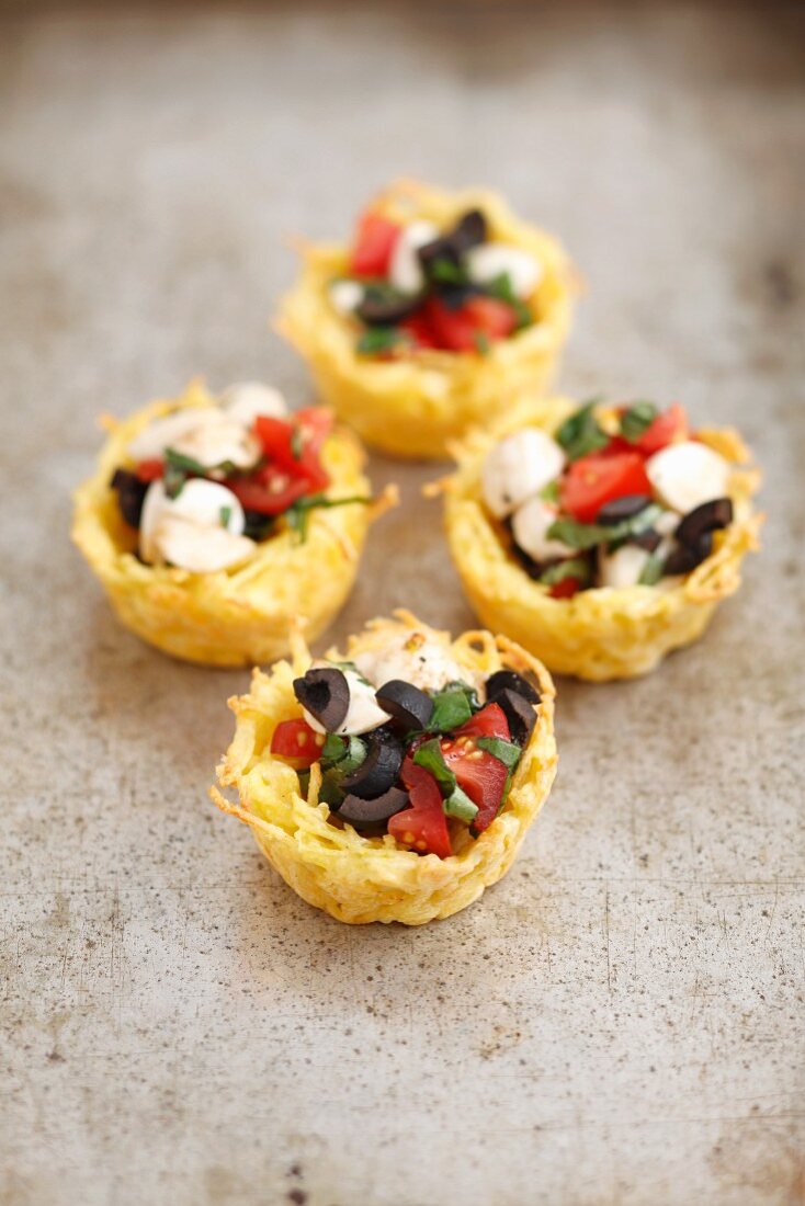 Baked pasta and Parmesan baskets filled with caprese salad