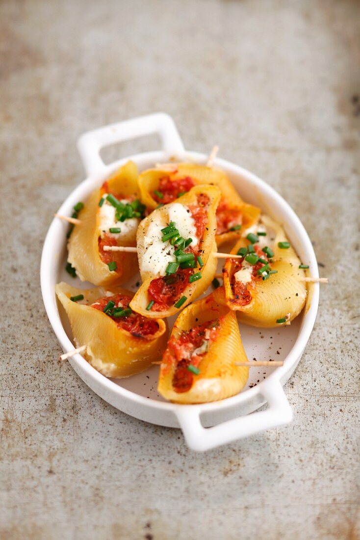 Baked conchiglie stuffed with pork with sour cream