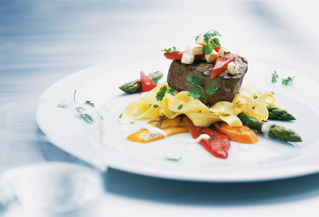Beef fillet steak with tagliatelle, asparagus and pepper