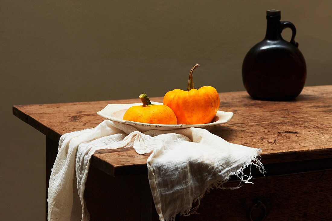 An autumnal arrangement featuring pumpkins on a wooden table