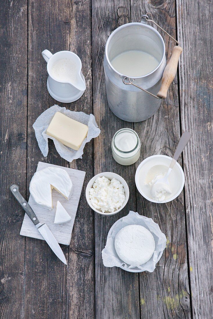 An arrangement of various dairy products on a wooden surface