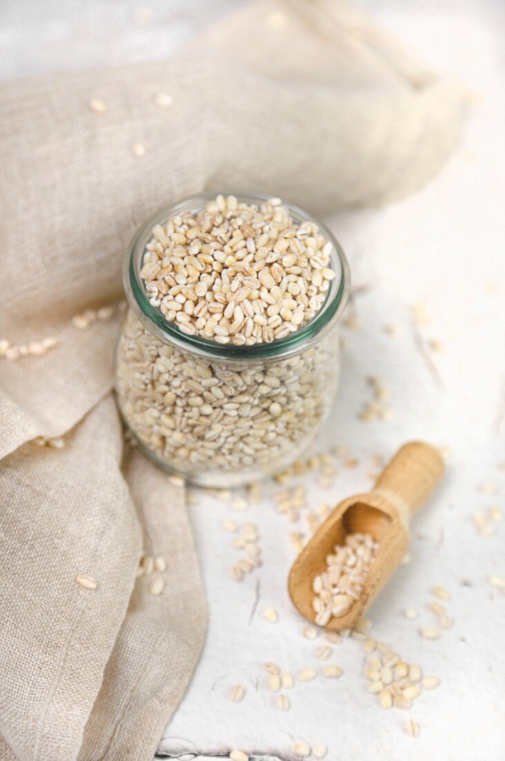 Barley in a jar and on a wooden scoop