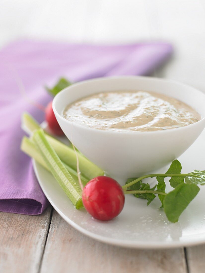 A tofu and dill dip with radishes and celery