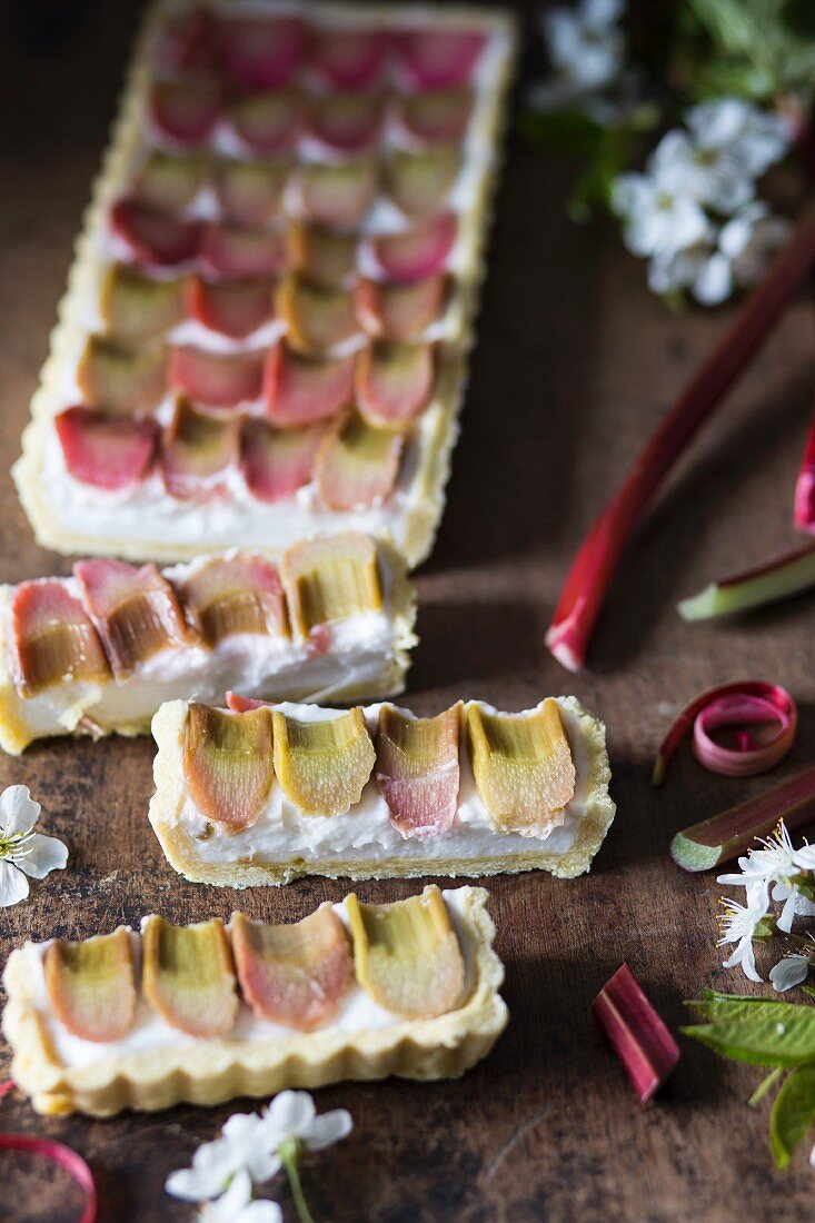Coconut cream and poached rhubarb tart, sliced