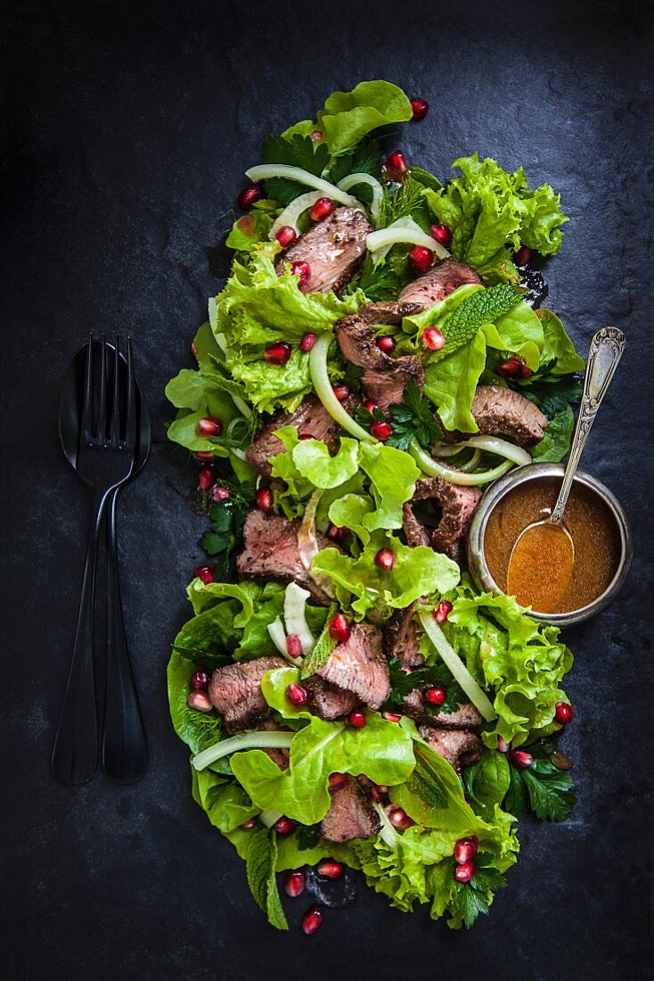 Venison and fennel salad with pomegranate seeds (seen from above)