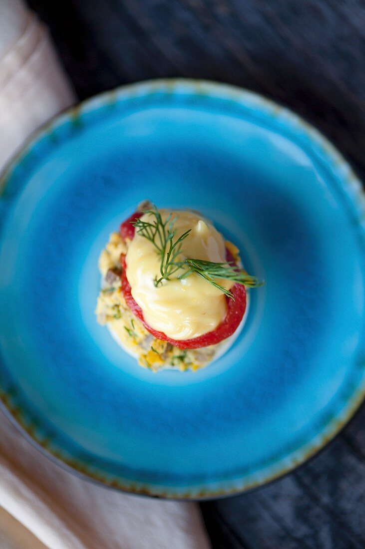 A devilled egg on a blue plate